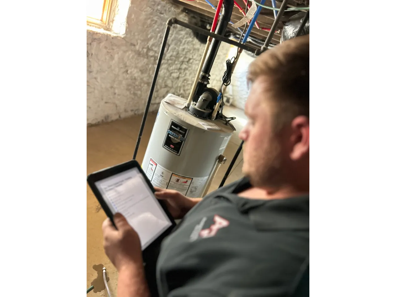 Allegiant Plumbing technician servicing a water heater